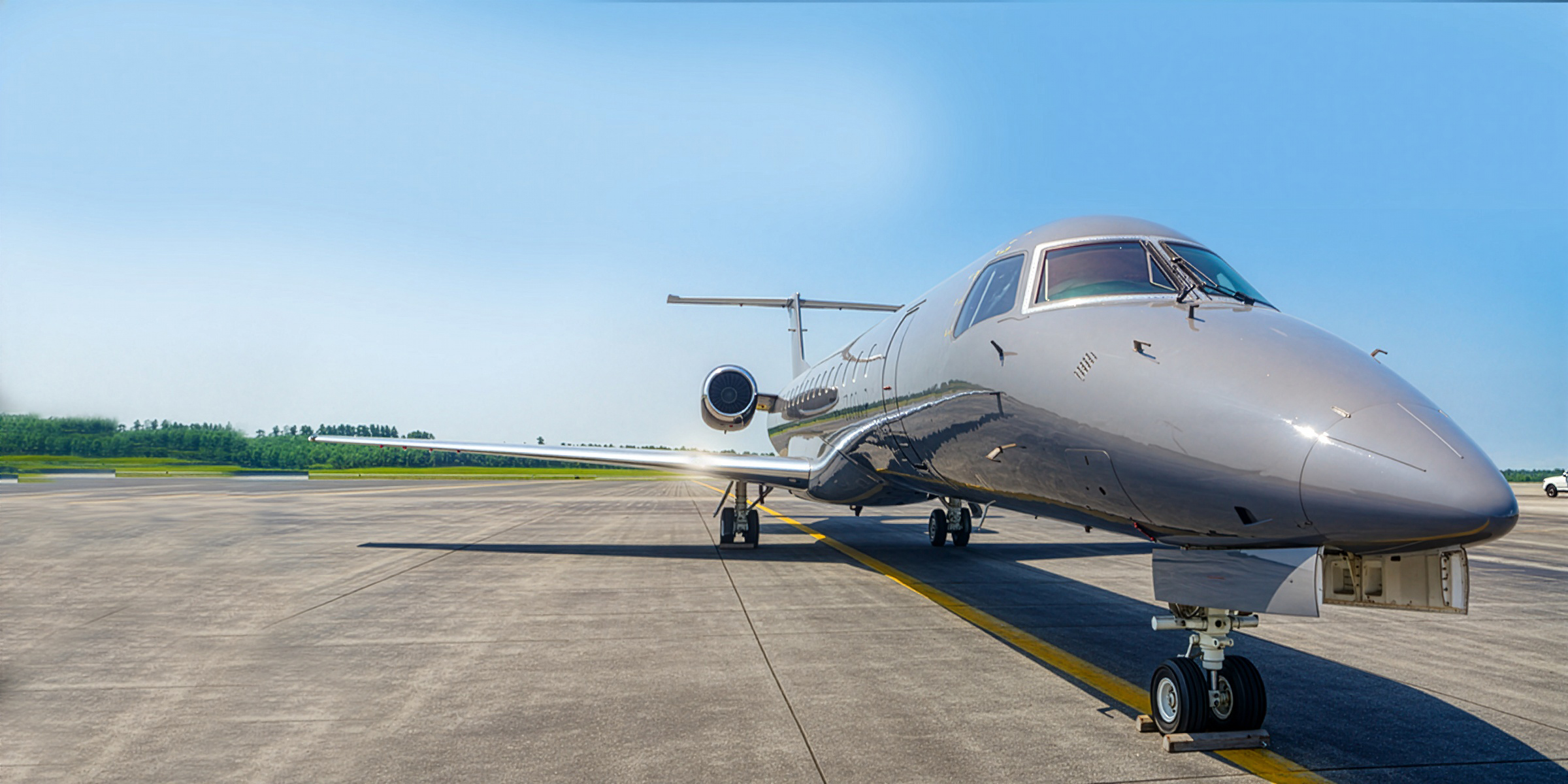 A photo of an ERJ3 plane on a runway.