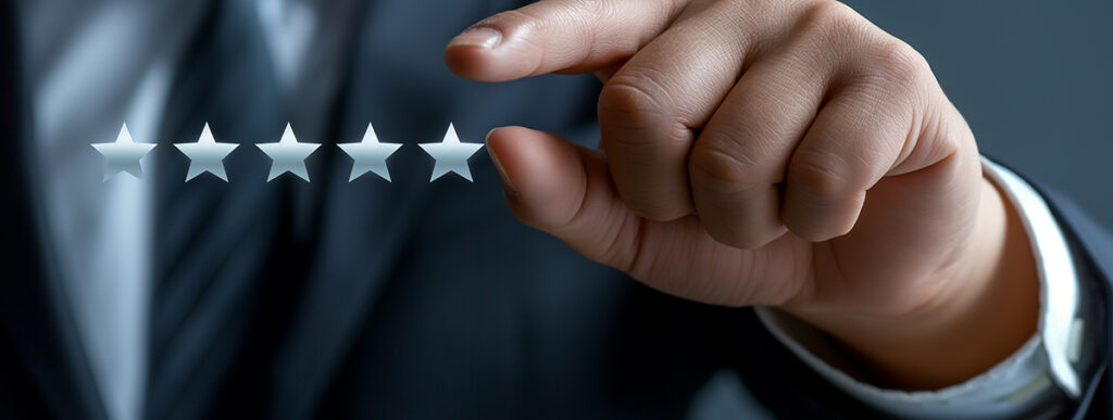 Businessman is touching a virtual five star icon from a set of five, giving the best score