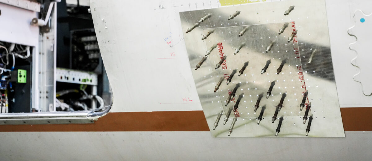 A photo of an attached metal plate on an airplane undergoing modification